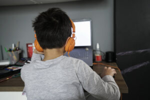 Boy learning at home on computer