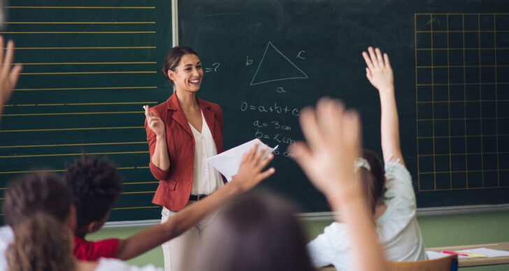 Teacher in front of her class, asking questions. - ACSA Resource Hub