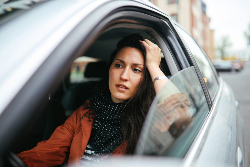 Young woman stuck in traffic commute.