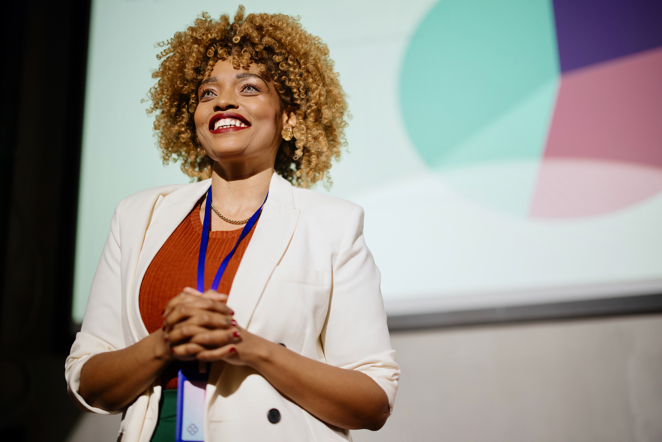 Female professional giving presentation in a conference.